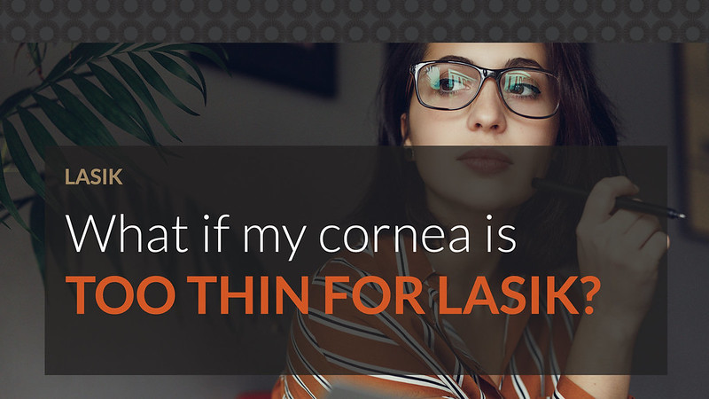 Young woman with glasses looking away from her laptop, concerned if her cornea is too thin for LASIK.