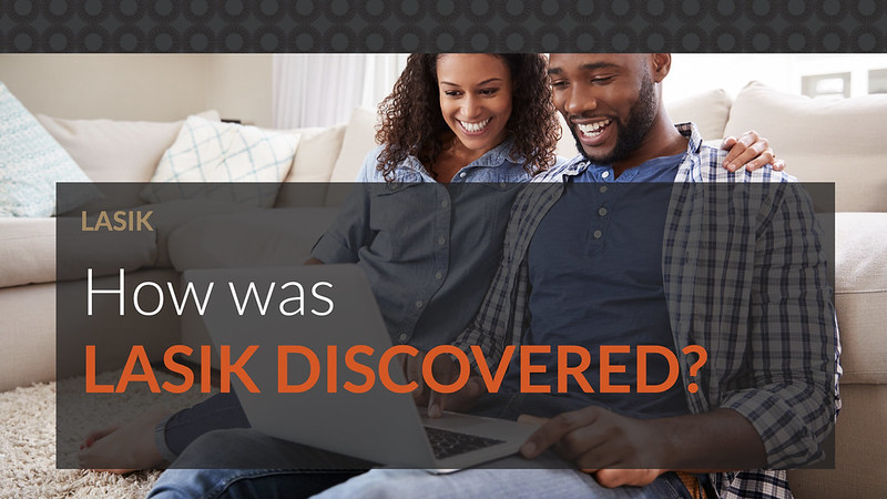 A couple sitting on the floor using their laptop to read about the discovery of LASIK