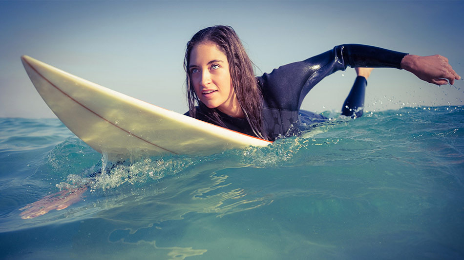 A young woman, surfing and enjoying life without glasses and contact lenses after having laser eye surgery