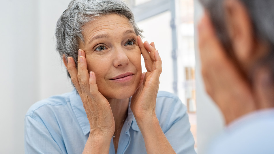A middle-aged woman looking in the mirror