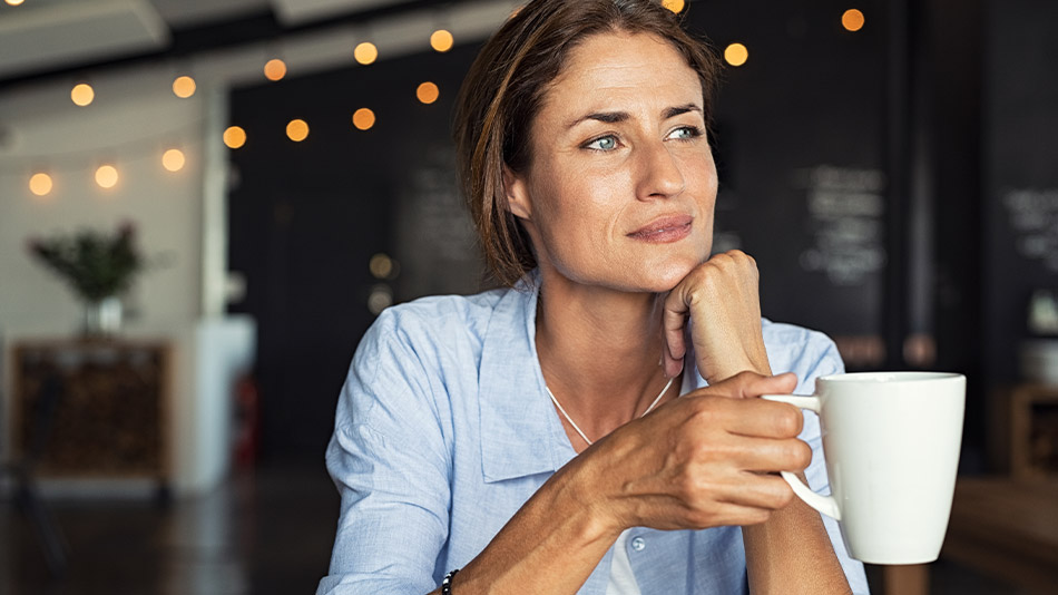 A mature woman at a cafe wondering whether presbyopia will worsen with age