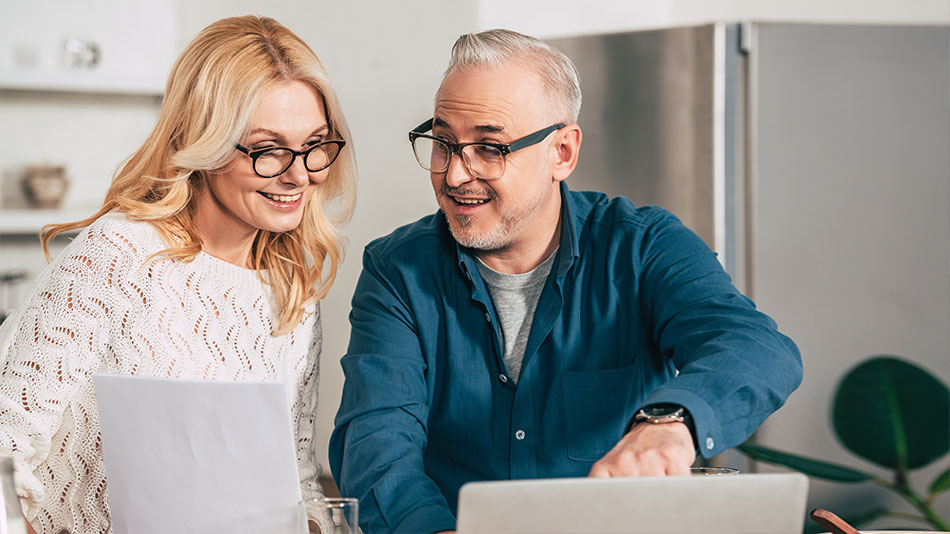 A mature couple with glasses, discussing the cost of lens replacement surgery