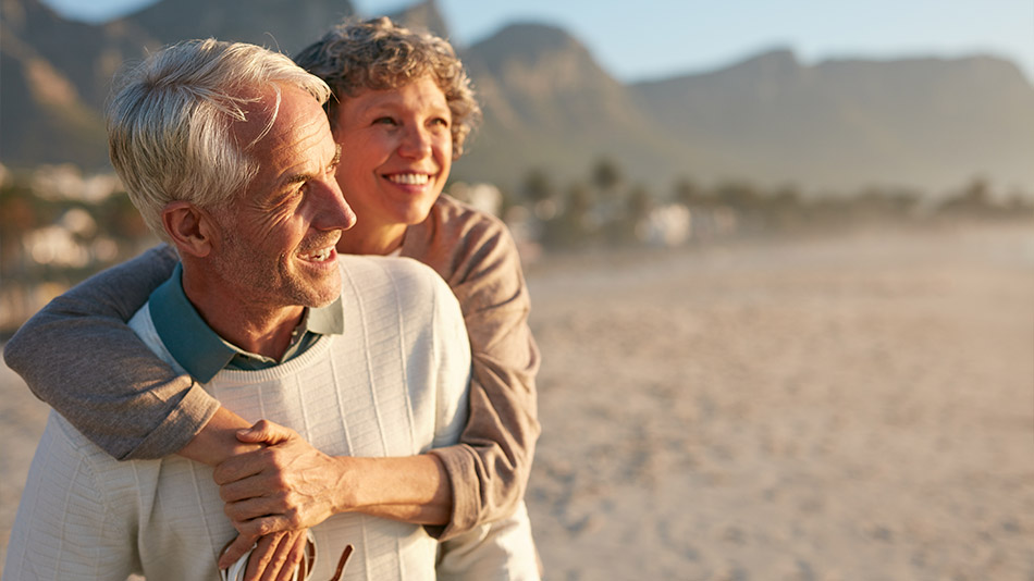Senior couple enjoying the sunset at the beach
