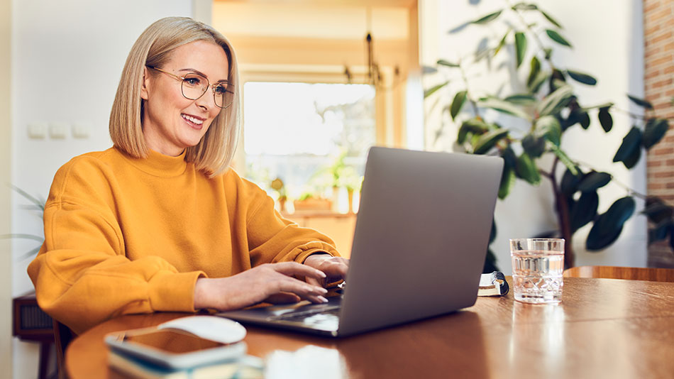 A woman with glasses researching options for treating Presbyopia