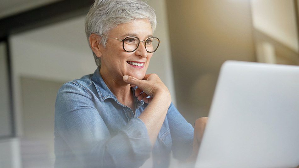 Senior woman with reading glasses contemplating the risks and complications of lens replacement