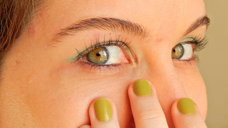 A close-up shot of a woman with beautiful green eyes.
