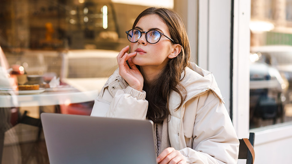 A beautiful woman sitting outside a cafe, thinking if ICL is better than LASIK.