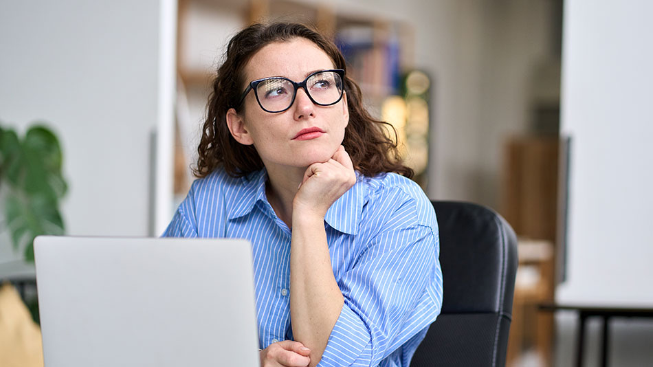 A young woman with glasses contemplates whether laser eye surgery can fix floaters.